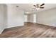 Bright living area showcasing laminate floors, a ceiling fan, neutral walls, and easy access to other rooms at 353 E Orange St, Altamonte Springs, FL 32701