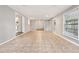 Spacious living area featuring tile flooring, recessed lighting, and seamless transition to the kitchen and backyard at 353 E Orange St, Altamonte Springs, FL 32701