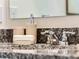 Bathroom vanity featuring a granite countertop, modern faucet, and coordinated soap and lotion dispensers at 3540 Fort Mellon Ln, Sanford, FL 32773