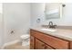 Bathroom with wood vanity, granite countertop, and bronze fixtures at 3675 Rundo Dr, Orlando, FL 32818