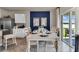 Dining area with a stylish table setting, stainless steel appliances, and outdoor access at 3751 Bluethread Way, Poinciana, FL 34759