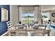 Bright dining room with a beautifully set table, white chairs, and a view to the outside at 3751 Bluethread Way, Poinciana, FL 34759
