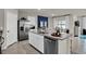 Spacious kitchen with stainless steel appliances, granite countertops, and an open layout to the dining area at 3751 Bluethread Way, Poinciana, FL 34759
