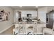 Well-lit kitchen with stainless steel appliances, granite countertops, and ample cabinet space at 3751 Bluethread Way, Poinciana, FL 34759