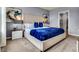Comfortable bedroom featuring an upholstered headboard, side tables, and an ensuite bathroom at 3751 Bluethread Way, Poinciana, FL 34759