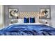 Stylishly decorated bedroom with a plush upholstered headboard and coordinated blue accents at 3751 Bluethread Way, Poinciana, FL 34759