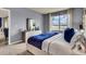 A serene bedroom with a view, featuring a dresser, large window, and a tufted headboard at 3751 Bluethread Way, Poinciana, FL 34759
