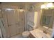 Bathroom featuring a glass shower, updated vanity, cabinet, and decorative starfish wall decor offering a fresh, modern look at 4153 S Atlantic Ave # 1070, New Smyrna Beach, FL 32169