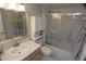 A full bath featuring an updated vanity and mirror, toilet, and tiled shower with a glass door and shower head at 4153 S Atlantic Ave # 1070, New Smyrna Beach, FL 32169