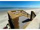 Beach access featuring a wooden walkway and a platform provides easy entry to the sandy shore and ocean views at 4153 S Atlantic Ave # 1070, New Smyrna Beach, FL 32169