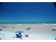 Wide beach view showing families and individuals enjoying the coastal scenery with tents and umbrellas on a sunny day at 4153 S Atlantic Ave # 1070, New Smyrna Beach, FL 32169
