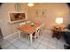 Cozy dining area with seating for four, a pass-through window to the kitchen, and charming decor at 4153 S Atlantic Ave # 1070, New Smyrna Beach, FL 32169