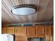 The kitchen features a decorative wood ceiling, bright wood cabinets and unique seaside decor at 4153 S Atlantic Ave # 1070, New Smyrna Beach, FL 32169