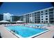 Exterior view of the pool and sun deck surrounded by multi-story buildings offering resort-style living and community amenities at 4153 S Atlantic Ave # 1070, New Smyrna Beach, FL 32169