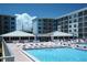 Exterior view of the pool and sun deck surrounded by multi-story buildings offering resort-style living and community amenities at 4153 S Atlantic Ave # 1070, New Smyrna Beach, FL 32169