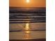 Beautiful sunset view reflecting over the ocean waves, creating a serene and golden ambiance at 4153 S Atlantic Ave # 1070, New Smyrna Beach, FL 32169