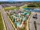 An aerial view of the community pool area, clubhouse, and waterpark amenities with ample parking at 4164 Paragraph Dr, Kissimmee, FL 34746