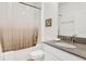 Clean bathroom with a shower-tub, modern fixtures, and white cabinets at 4164 Paragraph Dr, Kissimmee, FL 34746