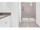Well-lit bathroom featuring walk-in shower with glass doors at 4164 Paragraph Dr, Kissimmee, FL 34746