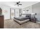 Well-lit bedroom with ceiling fan, soft carpet, and neutral wall color at 4164 Paragraph Dr, Kissimmee, FL 34746