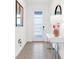 Bright entryway with neutral tile, console table, and modern decor at 4164 Paragraph Dr, Kissimmee, FL 34746