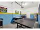 Finished garage featuring painted walls, air hockey table and ping pong table at 4164 Paragraph Dr, Kissimmee, FL 34746
