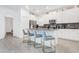Bright kitchen with white cabinets, gray countertops, and island seating at 4164 Paragraph Dr, Kissimmee, FL 34746