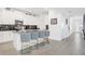Open kitchen with a large island, seating, stainless steel appliances, and lots of white cabinets at 4164 Paragraph Dr, Kissimmee, FL 34746
