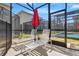 Outdoor seating area with lounge chairs and view of screened-in pool and backyard at 4164 Paragraph Dr, Kissimmee, FL 34746