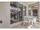 Outdoor patio area with modern furniture and view of screened pool through large sliding glass doors at 4164 Paragraph Dr, Kissimmee, FL 34746