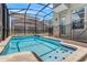 Screened-in pool with hot tub and views of the backyard and neighboring properties at 4164 Paragraph Dr, Kissimmee, FL 34746