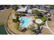 Community aerial view featuring a swimming pool, clubhouse, playground, and surrounding landscaping at 4175 Sw 46Th Ct, Ocala, FL 34474