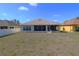 Home's backyard features a screened-in porch, a grassy area and adjacent properties at 4175 Sw 46Th Ct, Ocala, FL 34474