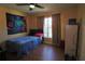 Cozy bedroom features warm colors, natural light, and wood-look laminate flooring at 4175 Sw 46Th Ct, Ocala, FL 34474
