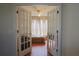 View of a bedroom through glass French doors, with a bed and hardwood flooring visible at 4175 Sw 46Th Ct, Ocala, FL 34474