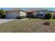 Inviting home exterior featuring a well-kept lawn, mature landscaping, and a convenient attached garage at 4175 Sw 46Th Ct, Ocala, FL 34474