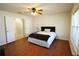 Bright main bedroom with hardwood floors, ceiling fan, and ensuite bathroom with glass shower at 4175 Sw 46Th Ct, Ocala, FL 34474