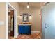 A unique bathroom with a blue vanity, colorful tiles, and a step-in shower at 429 E Gore St, Orlando, FL 32806