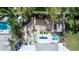 Aerial view of the home's backyard featuring seating area, swing set, and pristine pool at 435 Jessamine Ave, New Smyrna Beach, FL 32169