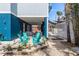 Charming backyard with Adirondack chairs, lush landscaping, and stylish gravel for relaxed outdoor living at 435 Jessamine Ave, New Smyrna Beach, FL 32169