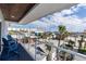 Balcony seating offering expansive views of the cityscape and palm trees against a blue sky at 435 Jessamine Ave, New Smyrna Beach, FL 32169