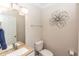 Well-lit bathroom with neutral paint, granite countertop, flower art, and chrome fixtures at 435 Jessamine Ave, New Smyrna Beach, FL 32169