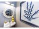 Charming bathroom with a white sunburst mirror, unique wall art, and a vessel sink at 435 Jessamine Ave, New Smyrna Beach, FL 32169