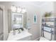 Bright bathroom with a view of the main bedroom through the mirror at 435 Jessamine Ave, New Smyrna Beach, FL 32169