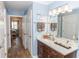 Well-lit bathroom with blue walls, wood floors, a modern vanity, and an open view at 435 Jessamine Ave, New Smyrna Beach, FL 32169