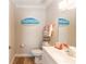 Bathroom featuring beach-themed decor, a white vanity, and wood-look flooring at 435 Jessamine Ave, New Smyrna Beach, FL 32169