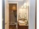 Bathroom featuring a granite countertop, traditional vanity, and enclosed shower with patterned curtain at 435 Jessamine Ave, New Smyrna Beach, FL 32169