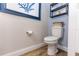 Bathroom features a toilet, base moulding, and wall art at 435 Jessamine Ave, New Smyrna Beach, FL 32169