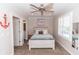Well-lit bedroom featuring a ceiling fan, shuttered windows, and coastal decor at 435 Jessamine Ave, New Smyrna Beach, FL 32169