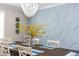 Elegant dining room featuring wood floors, modern wall decor, and a stylish chandelier at 435 Jessamine Ave, New Smyrna Beach, FL 32169